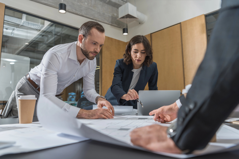 A Business Owner's Guide to a Practical Guide to Using image Colleagues discussing the integration of AI in their advertising efforts