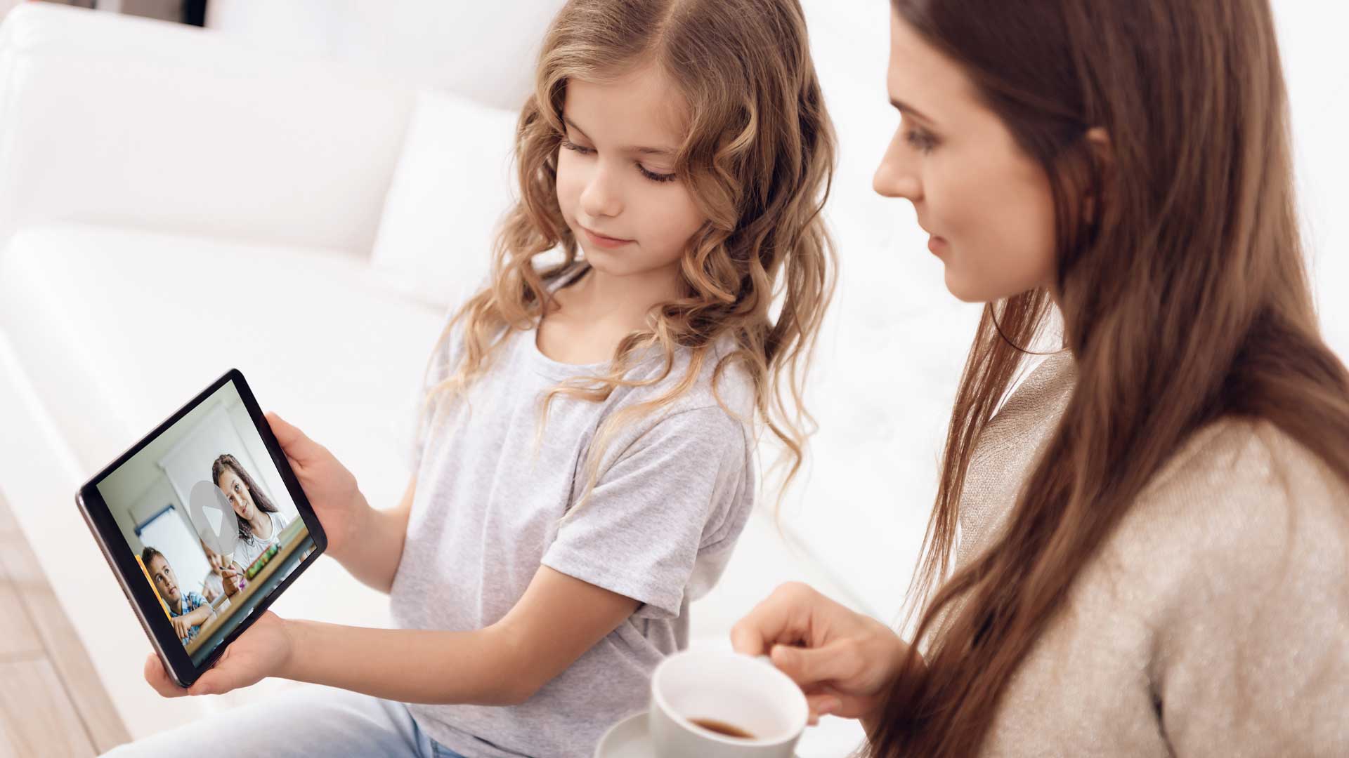 Girl and mother check out Greenfield Academy video on iPad.